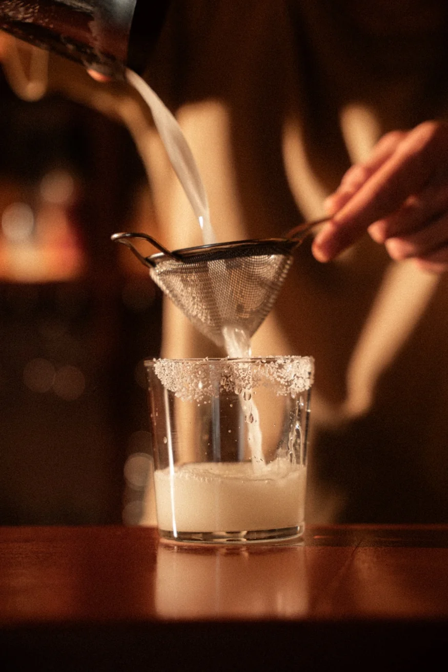 Mezcal margarita being strained at Pūblico Mezcaleria — handcrafted cocktails in Mykonos Town